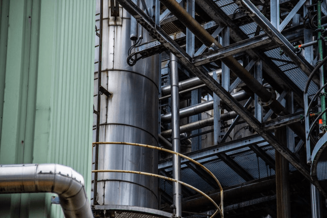 MacSync 4-20mA to LoRaWAN converter connected to a legacy industrial flow meter for wireless data monitoring
